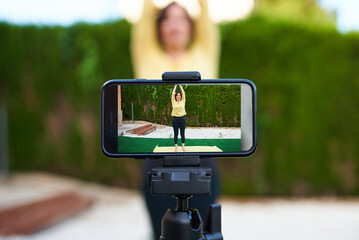 A content creator records herself doing yoga