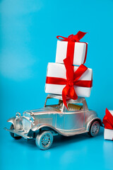 Silver car with gifts on a blue background.