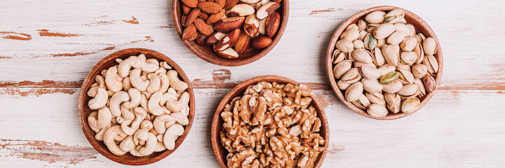Different kind of nuts in wooden bowls