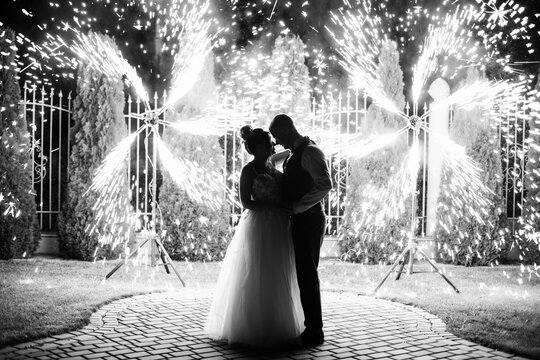 wedding couple dancing on fireworks background