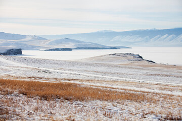 Grass and snow on Olkhon Island. Winter landscape