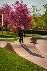 A boy roller-skates in a rollerdrom