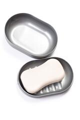 Travel soap in plastic soap dish isolated on white background