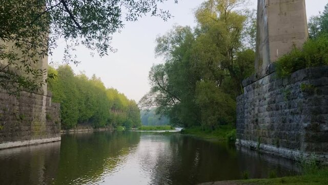 River flowing under a tall bridge in Elora Ontario