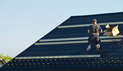 Installing modern black solar panels on the roof