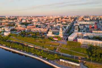 Fototapeta na wymiar Aerial view of Perm and historical building, Kama river with bridge in sunny summer day with green trees in the sunset