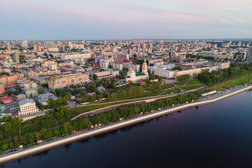 Fototapeta na wymiar Aerial view of Perm and historical building of art gallery, Kama river with bridge in sunny summer day with green trees in the sunset