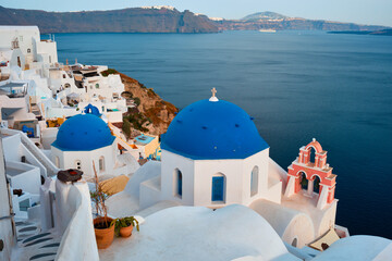 Famous view from viewpoint of Santorini Oia village with blue dome of greek orthodox Christian church