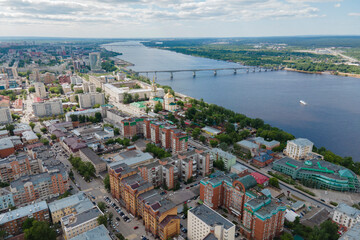 Naklejka premium Aerial view of Perm and historical building of art gallery, Kama river with bridge in sunny summer day with green trees