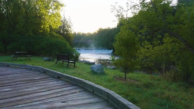 Wooden walkway in a park with waterfalls