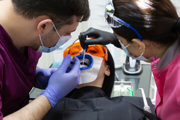 A woman at a dentist's teeth whitening appointment