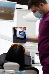 A woman at a dentist's teeth whitening appointment