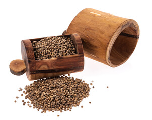 dried coriander seeds in a wooden boxing plate isolated on white
