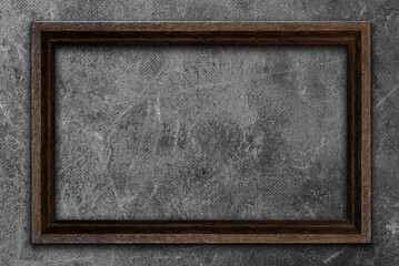 empty wooden photo frame on old gray wall