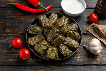 Dolma on a wooden rustic background. Traditional Caucasian, Turkish and Greek cuisine