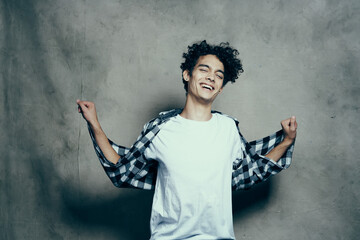 Cheerful guy curly hair plaid shirt studio cropped look lifestyle