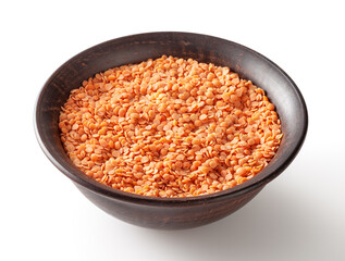 Red lentils in ceramic bowl isolated on white background