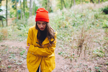 Thoughtful lady walking in autumn nature