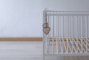 baby bed is empty. Wooden white bed for toddler