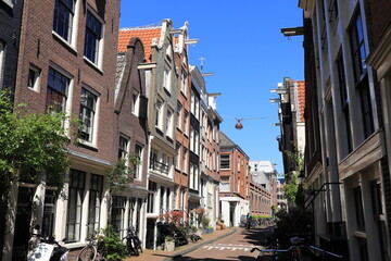 Amsterdam Jordaan Street View with Traditional House Facades and Man on a Bicycle

