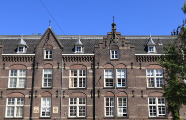 Fototapeta na wymiar Amsterdam Jordaan Traditional Brown Brick Building Facade with Blue Sky