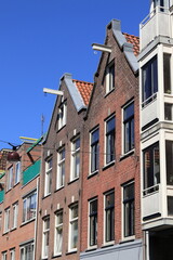 Fototapeta na wymiar Amsterdam Jordaan Traditional House Facades with Spout Gables Against a Blue Sky