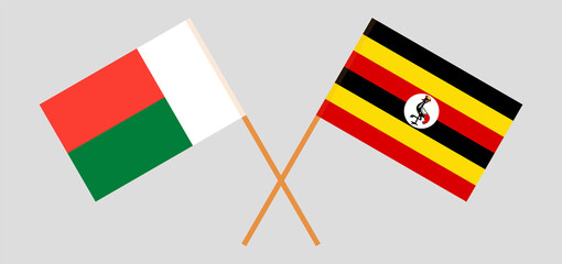 Crossed flags of Madagascar and Uganda. Official colors. Correct proportion