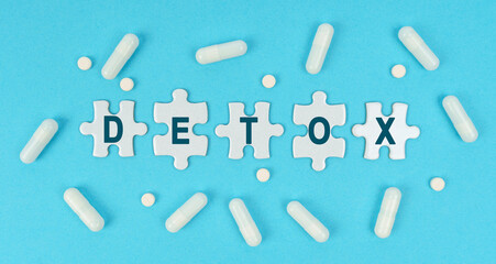 On a blue background, there are pills and puzzles with the inscription - Detox