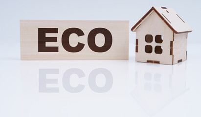 There is a wooden house and a sign on the table - ECO
