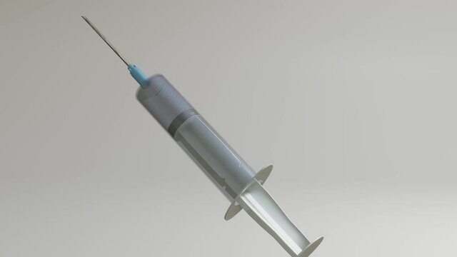 a three-dimensional model of a disposable syringe rotates slowly on a gray background. looped moving background. 3d render