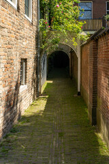 Fototapeta na wymiar Picturesque gate with brick ground and building in Netherlands