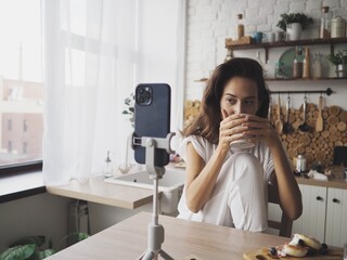 young woman works on the computer at home. Remote work at home, talking by video communication on the phone