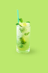 Mohito cocktail on a green background with lemon and mint