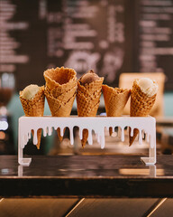 Variety of ice cream in a waffle cup on caffe background