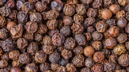 Large pile of allspice peas. Food background.Background made of middle eastern traditional spice . Top view.Textures of colorful spices and condiments.