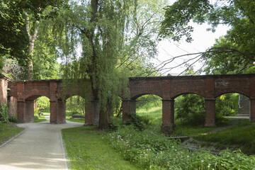 An arched red stone bridge in an old castle