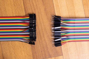 Set of multicolored wires on wooden background