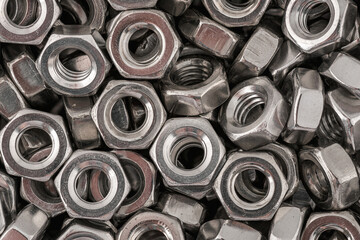 Stainless steel nuts background macro photo.