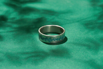 Close up view of silver ring with floral embossing