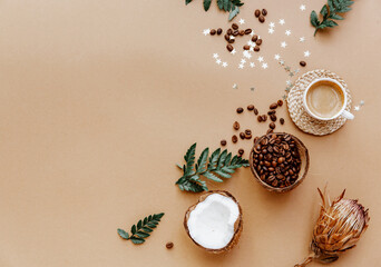 Obraz na płótnie Canvas Stylish blogger background for social media with coffee cup on brown. Coconut and coffee beans, natural products, zero waste. Flat lay, copy space