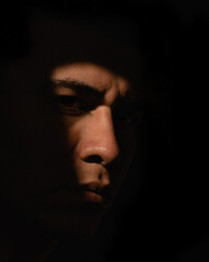 portrait of a man behind shadows