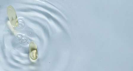Beauty skin care product. Water drop background. Hyaluronic serum. Vitamin drop pill capsule....