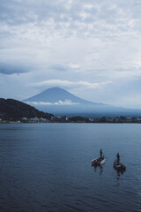 Obraz premium Fishermen near the mount Fuji in the misty day. 