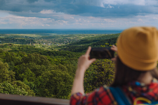 Woman hands taking photo of the nature with her smartphone