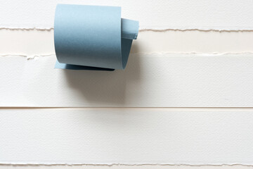 fine deckle edged art papers with blue paper swirl - photographed from above in a flat lay style