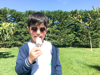 Fototapeta premium Small child eating ice cream