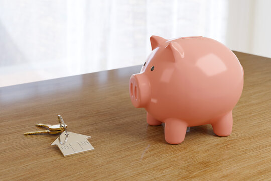 Keychain in the shape of a house next to a piggy bank on a table. Real estate purchase concept. 3d illustration.