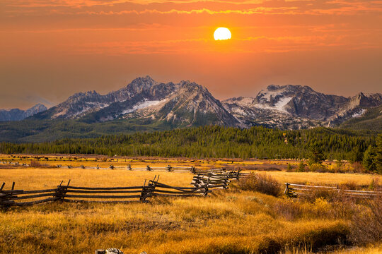 a split rail fence, pasture and meadow, and the Sawtooth Mountains near Stanley, Idaho.