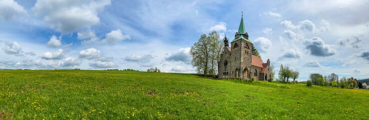 Fototapeta na wymiar Panorama of Church Of The Divine Heart Of The Lord in small village Borovnicka, Pokrkonosi region in Czech republic built in 1928