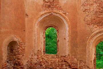 A window with the remains of a lattice in a ruined old church. Inside view. Russia, Smolensk region, 1753.